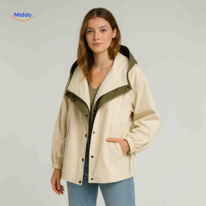 Lightweight AquaShell trench coat in cream with green lining and collar.