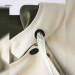 AquaShell trench coat detail showing premium buttons and closure.
