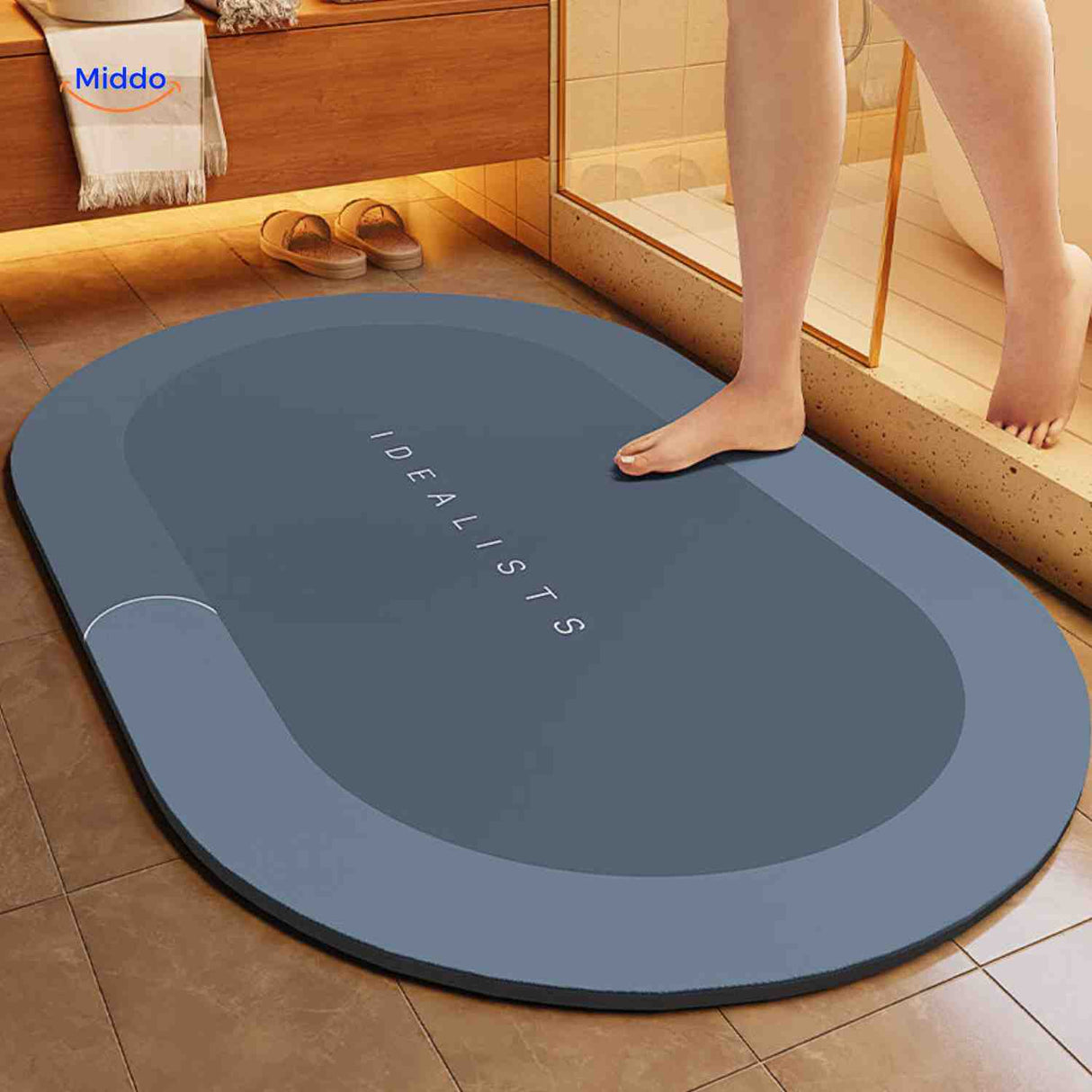 Oval blue-gray water-absorbing bath mat with non-slip grip technology.