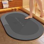 Dark gray oval quick-dry water-absorbing bath mat for everyday use.