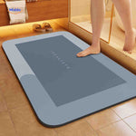 Light blue-gray rectangle quick-dry bath mat with absorbent surface.