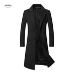 Black wool trench coat worn full-length with traditional military-inspired cut.
