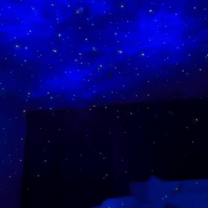 Astronaut galaxy projector creating starfield ceiling projection with constellation patterns.
