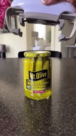 Automatic jar opener handles pickle jars and sealed containers easily.