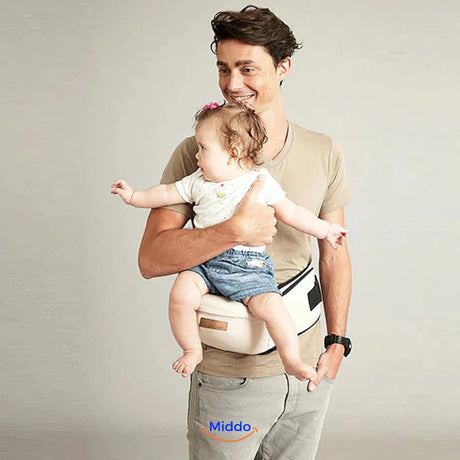Father wearing baby hip carrier while holding toddler securely on his hip.