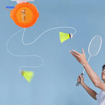 Man playing with Spinpro badminton trainer indoors for solo practice