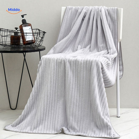 Dark blue bath towel made from quality material with absorbent properties.