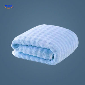 Light blue waffle-textured bath towel for spa-like comfort.