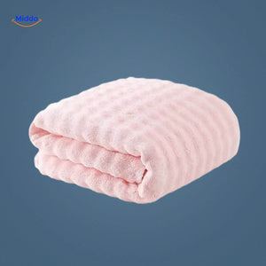 Pink waffle-textured bath towel with superior absorbency.
