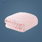 Pink waffle-textured bath towel with superior absorbency.
