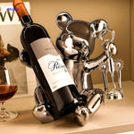 Silver-finished bear wine bottle holder with built-in corkscrew, combining decoration and practical function.