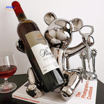 Playful wooden bear wine bottle holder ready to uncork a bottle, perfect for home bar or gifting.