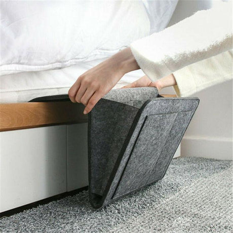 BedCaddy bedside storage organizer in dark gray felt fabric.