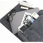 BedCaddy bedside organizer holding magazines, phone, and eyeglasses nearby.