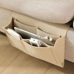 BedCaddy bedside storage organizer in warm beige felt with storage pockets.