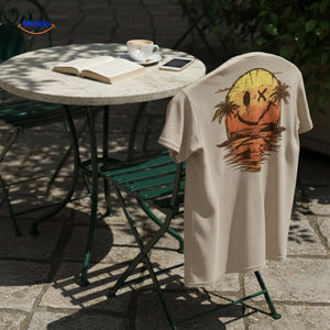 Beige cotton t-shirt with smiley print worn outdoors on comfortable chair.