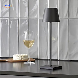 Black portable dimmable LED lamp displayed on a desk or table.