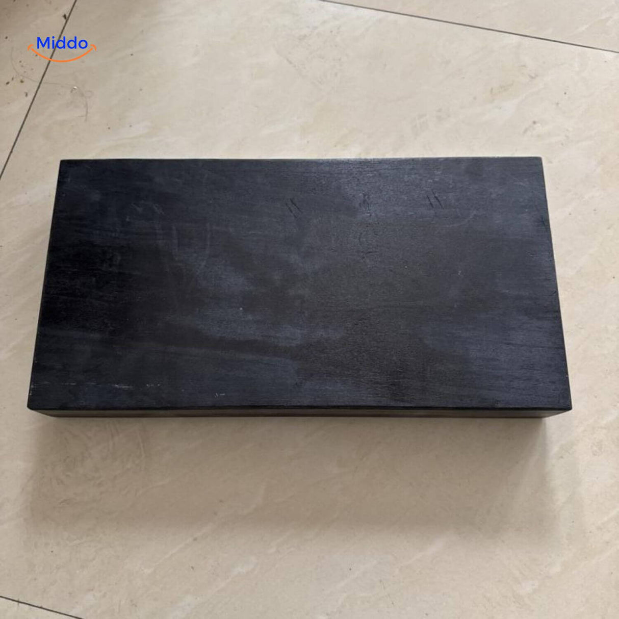 Black floating shelf demonstrating concealed storage space for hidden items.