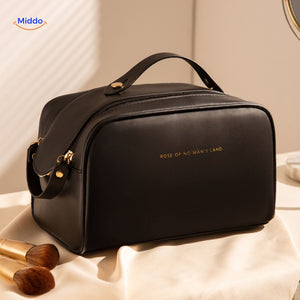 Black travel pouch with elegant gold accent details