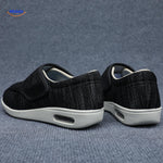 Black support shoes with velcro closure shown from back angle.