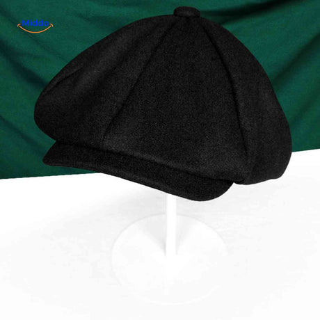 Black wool newsboy cap with classic vintage flat cap construction.
