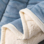 Close-up detail of plush wool blanket fabric texture and softness.