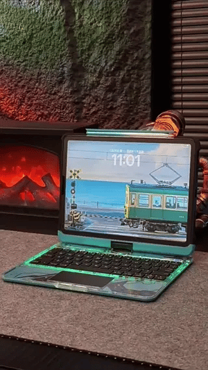 Blue illuminated iPad keyboard case with retro train theme design.