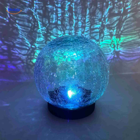 Solar lamp with blue magical light effects and glass globe design.