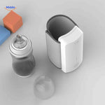 Top-down view of the cordless bottle warmer with a baby bottle inserted inside