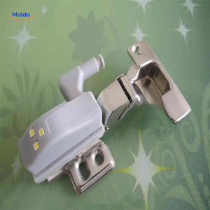 Close-up view of Cabintra LED light mounted directly on cabinet door hinge.