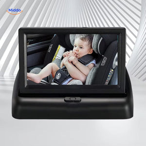Baby car monitor displaying rear-seat view of infant in car seat during driving.