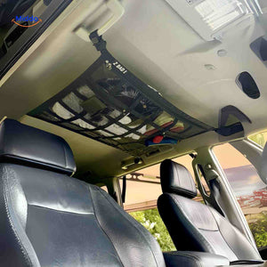 Car interior roof storage bag with multiple net compartments for easy access.