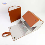 Caramel 2-slot foldable eyeglasses case open with a pair of clear-frame glasses resting inside.