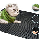 Cat using the waterproof litter mat in a home environment