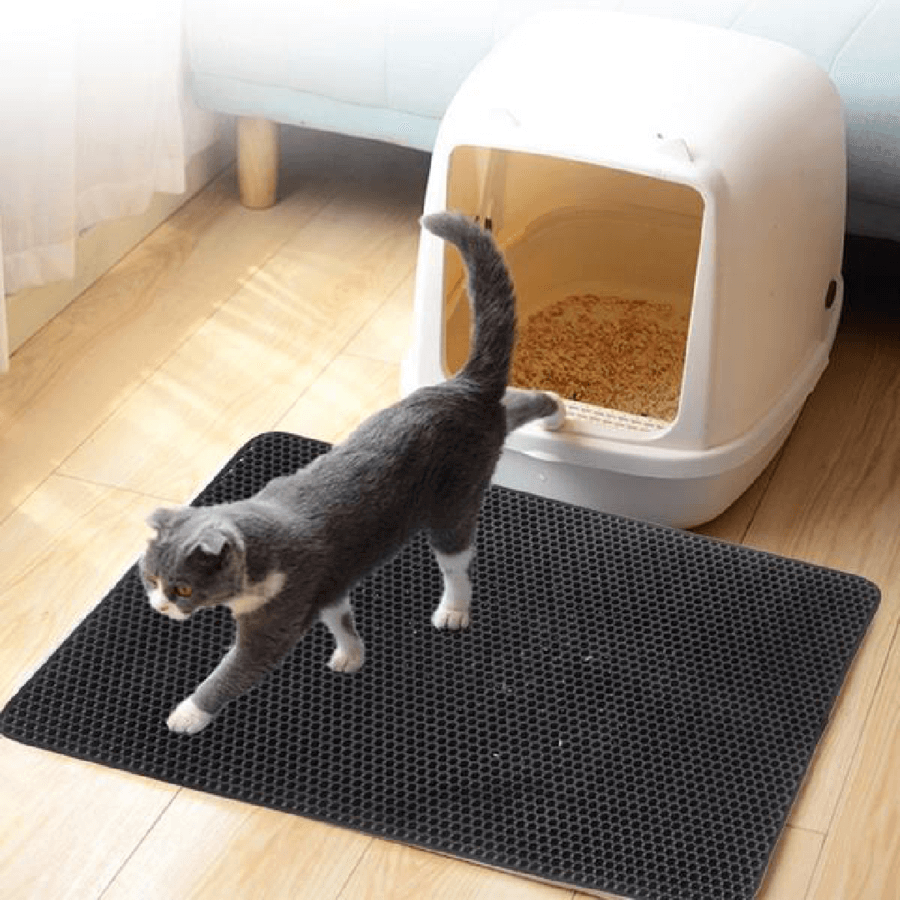Cat litter mat trapping and containing litter around the litter box