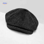 Charcoal houndstooth wool flat cap with timeless vintage appeal.