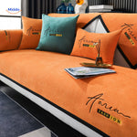 CheniLux chenille sofa cover in orange and green colorway, showing soft texture and anti-slip design.