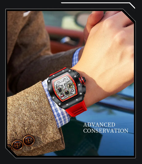 Men's chronograph sport watch with red and black dial on arm.