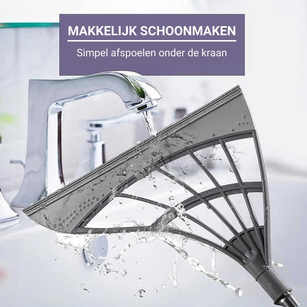 CLEANX broom head rinsing under water for easy maintenance and quick cleaning between uses.