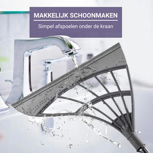 CLEANX broom head rinsing under water for easy maintenance and quick cleaning between uses.