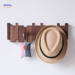 Piano coat rack showcasing hats and accessories on its foldable wooden hooks.