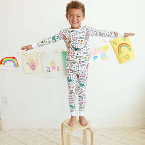 Farm-theme color-your-own pajama displayed on happy child.
