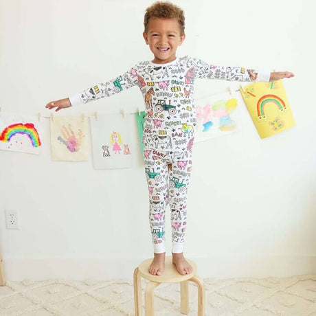 Farm-theme color-your-own pajama displayed on happy child.
