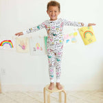 Farm-theme color-your-own pajama displayed on happy child.
