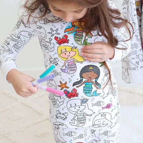 Mermaid-theme color-your-own pajama with child actively coloring.