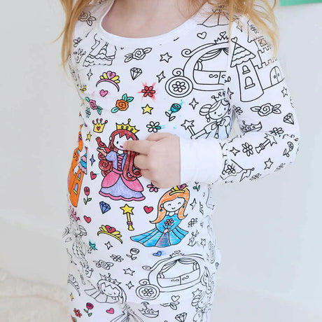 Princess-design color-your-own pajama on child with coloring markers.