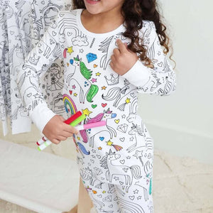 Unicorn-theme color-your-own pajama being colored by child.