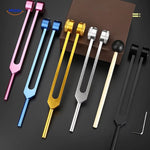 Colorful healing tuning fork set with complete therapeutic accessories.