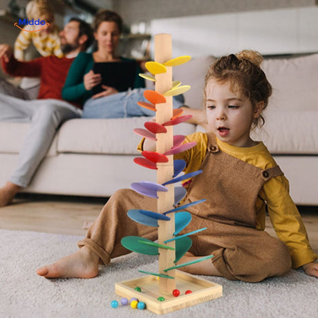 Children enjoying colorful ball run tree during family playtime.