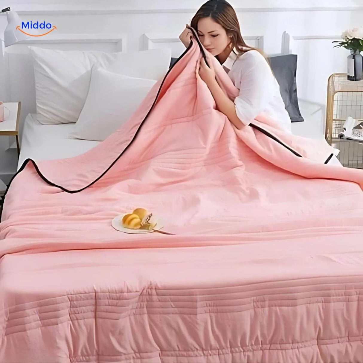 Cooling blanket in light pink showcasing breathable lightweight summer design.